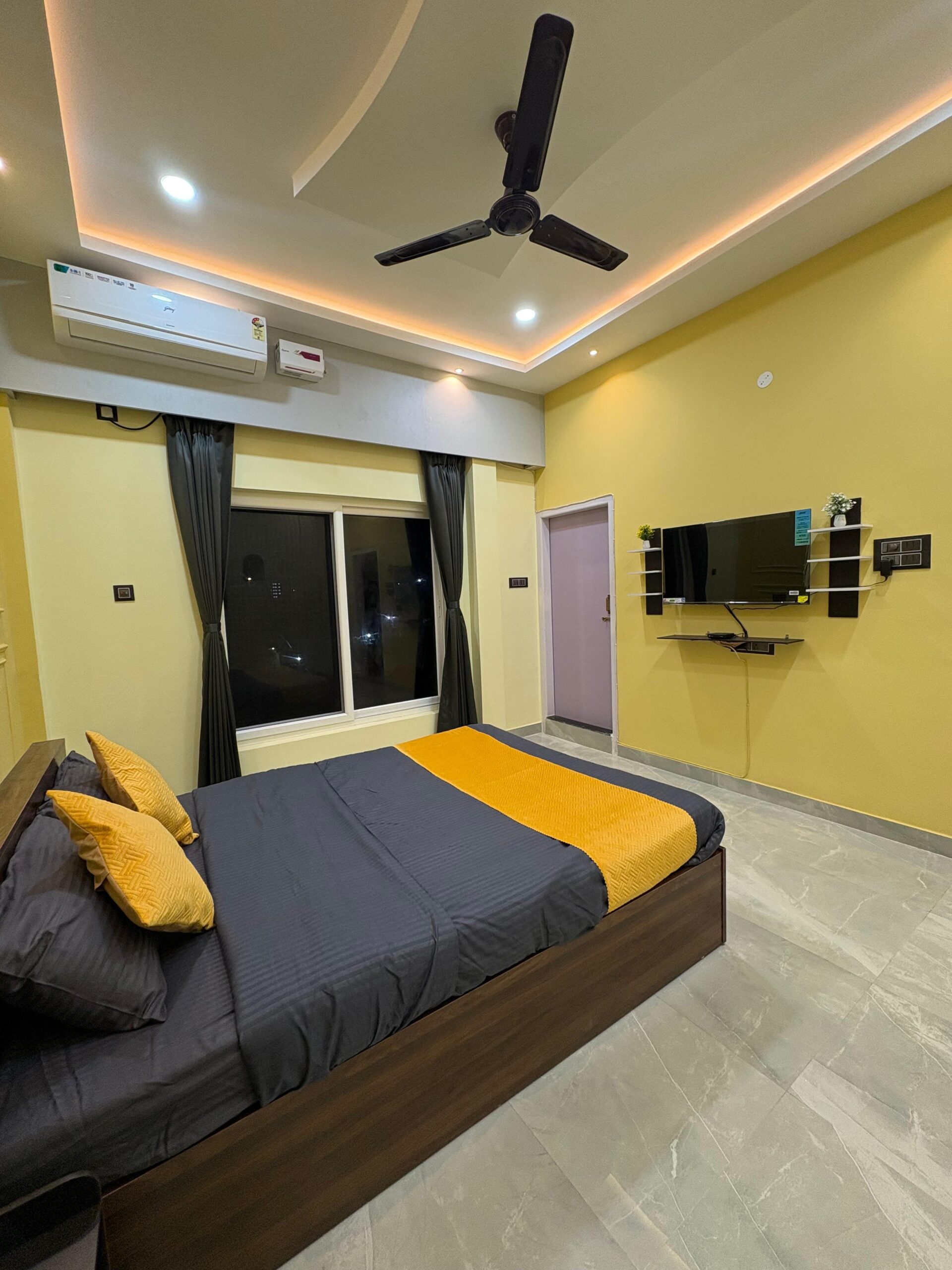 yellow bedroom with tv